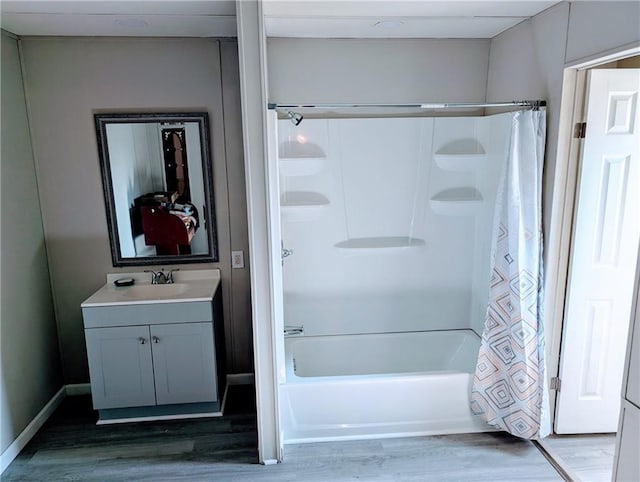 bathroom featuring hardwood / wood-style floors, shower / tub combo, and vanity