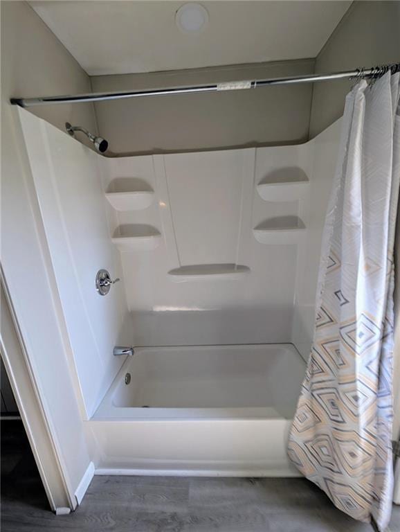 bathroom featuring shower / bathtub combination with curtain and wood-type flooring