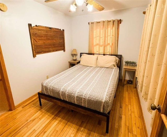 bedroom with ceiling fan and wood-type flooring