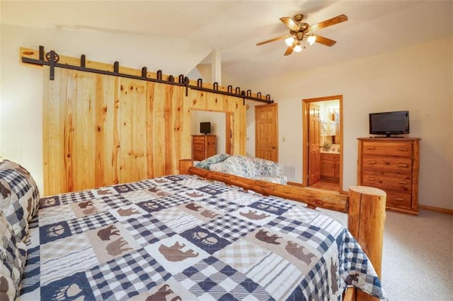 bedroom featuring vaulted ceiling, carpet floors, and connected bathroom