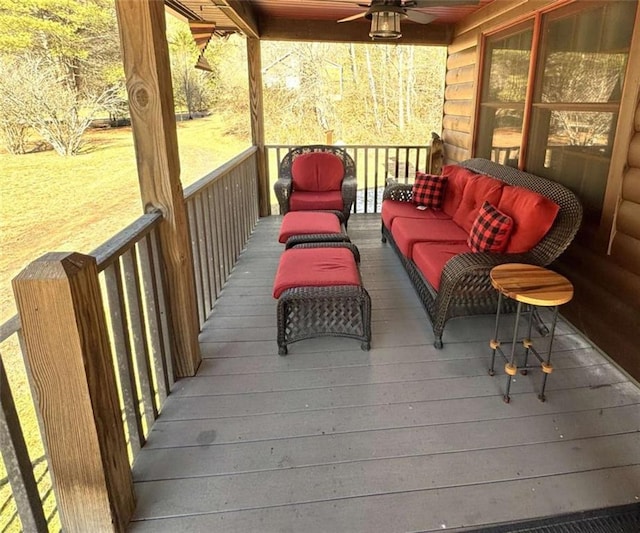 wooden deck with outdoor lounge area, a lawn, and ceiling fan