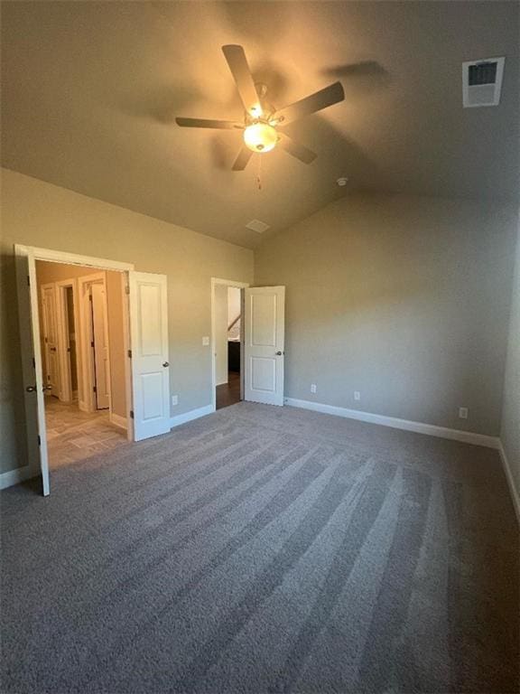 unfurnished bedroom with ceiling fan, lofted ceiling, and carpet