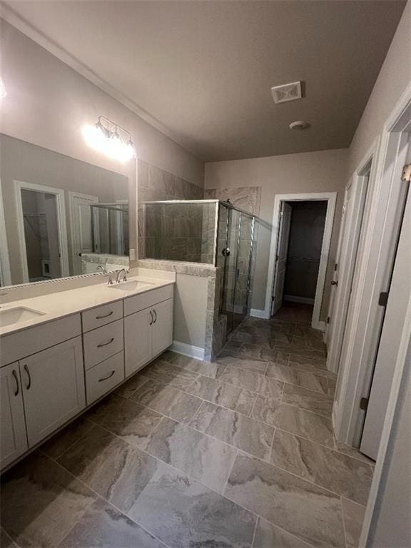 bathroom featuring vanity and an enclosed shower