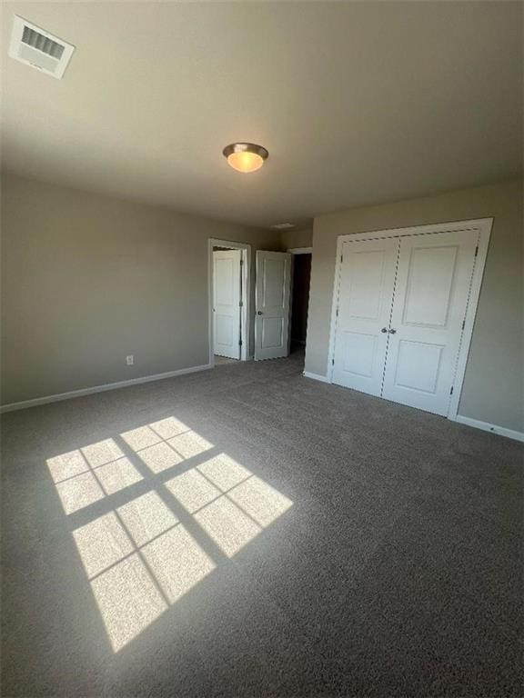 unfurnished bedroom featuring carpet floors and a closet