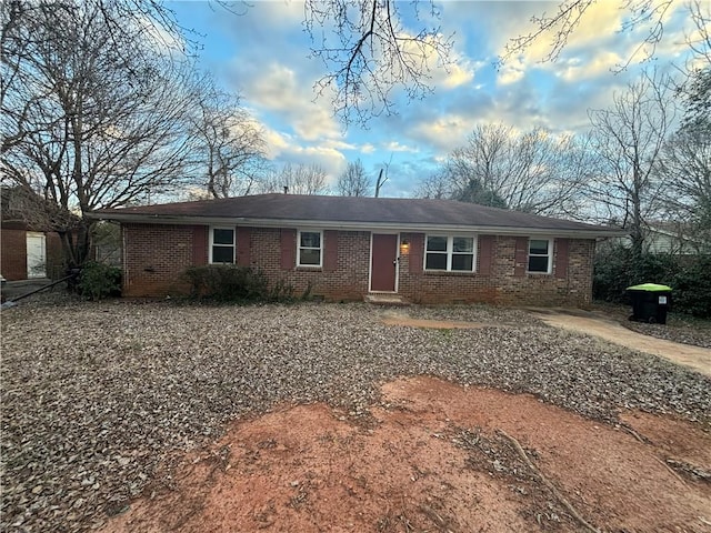 ranch-style house featuring brick siding