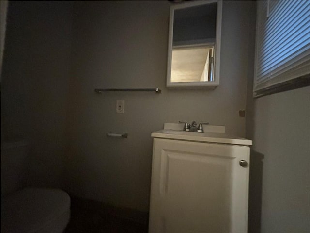 half bathroom featuring toilet and vanity