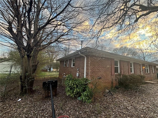 view of side of property featuring brick siding