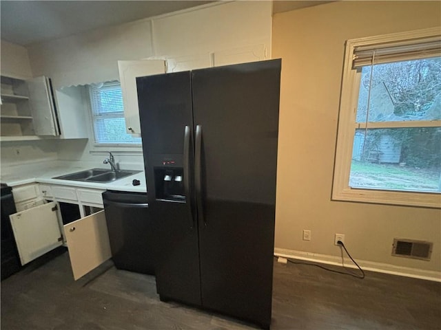 kitchen featuring a sink, visible vents, white cabinets, light countertops, and black appliances