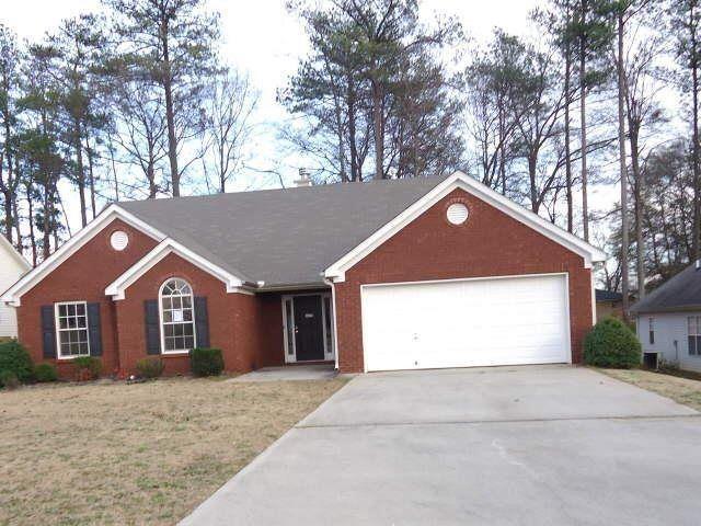 single story home with a front lawn and a garage