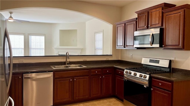 kitchen featuring a peninsula, ceiling fan, appliances with stainless steel finishes, and a sink