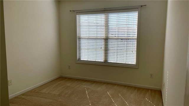 carpeted empty room with baseboards and a healthy amount of sunlight