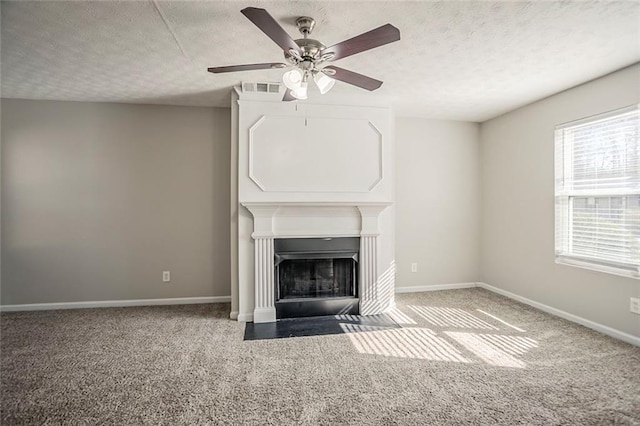 unfurnished living room featuring a fireplace with flush hearth, baseboards, visible vents, and carpet flooring