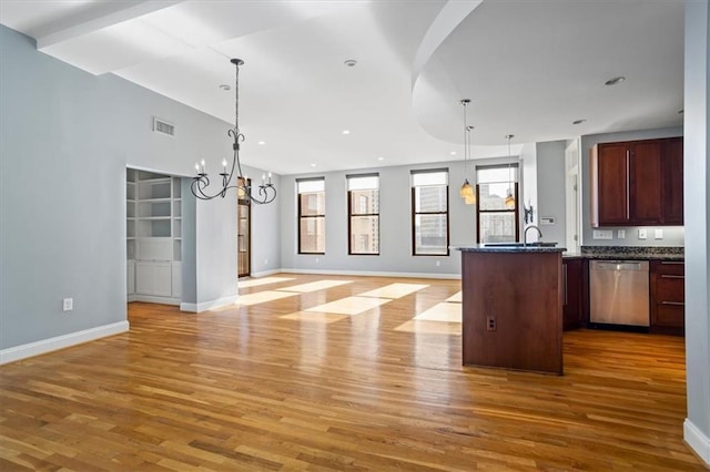 kitchen with visible vents, open floor plan, light wood finished floors, dishwasher, and a notable chandelier