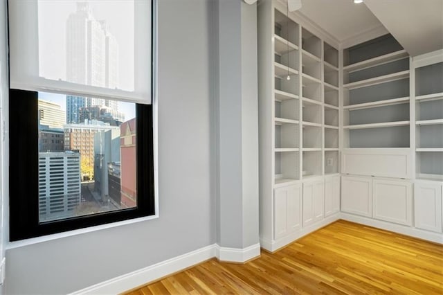 empty room with baseboards and light wood-style flooring
