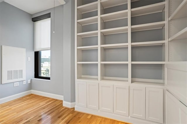 interior details featuring baseboards, wood finished floors, and visible vents