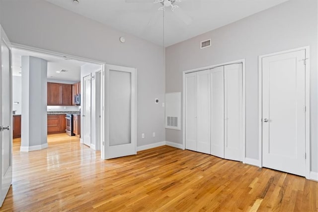 unfurnished bedroom featuring visible vents, connected bathroom, light wood finished floors, and baseboards