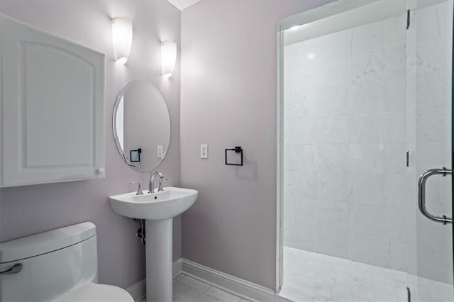 bathroom featuring baseboards, a shower stall, toilet, and marble finish floor