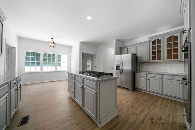 1460 Bakers Bridge Rd, Douglasville, GA 30134 - kitchen with stainless steel appliances, gray cabinets, wood finished floors, and recessed lighting