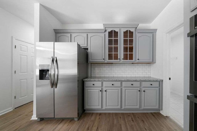 1460 Bakers Bridge Rd, Douglasville, GA 30134 - kitchen featuring stainless steel fridge with ice dispenser, gray cabinetry, glass insert cabinets, and dark wood-type flooring