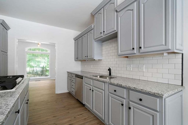 1460 Bakers Bridge Rd, Douglasville, GA 30134 - kitchen featuring a sink, gas cooktop, stainless steel dishwasher, tasteful backsplash, and dark wood-style floors