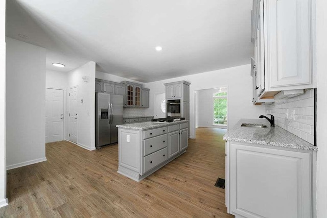 1460 Bakers Bridge Rd, Douglasville, GA 30134 - kitchen featuring appliances with stainless steel finishes, gray cabinets, a kitchen island, and recessed lighting