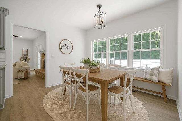 1460 Bakers Bridge Rd, Douglasville, GA 30134 - dining area featuring baseboards, light wood-style floors, and a chandelier