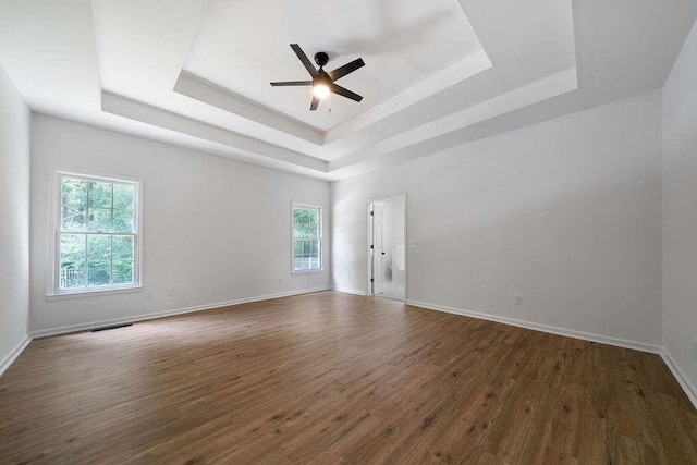 1460 Bakers Bridge Rd, Douglasville, GA 30134 - spare room featuring a raised ceiling, dark wood finished floors, ceiling fan, and baseboards
