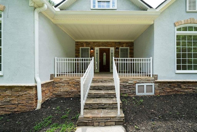 1460 Bakers Bridge Rd, Douglasville, GA 30134 - doorway to property featuring covered porch, stucco siding, and stone siding