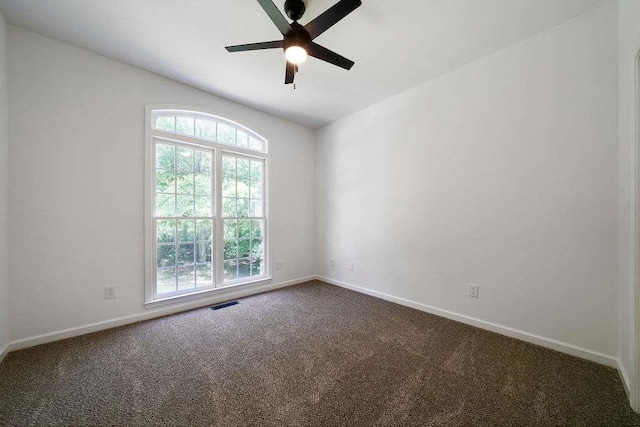 1460 Bakers Bridge Rd, Douglasville, GA 30134 - spare room featuring plenty of natural light, dark carpet, ceiling fan, and baseboards