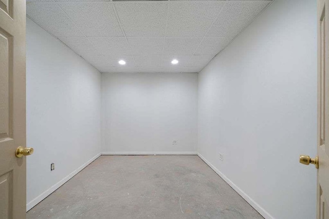 1460 Bakers Bridge Rd, Douglasville, GA 30134 - empty room featuring unfinished concrete flooring, baseboards, recessed lighting, and a drop ceiling