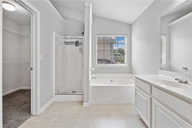 181 Ridgemont Rd, Canton, GA 30114 - full bathroom with a stall shower, vaulted ceiling, a bath, a walk in closet, and vanity