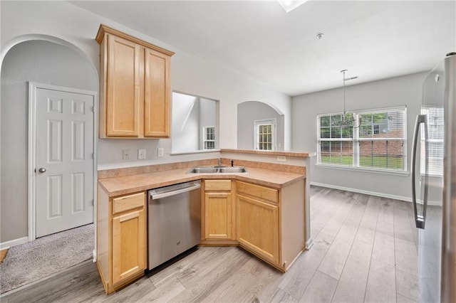 181 Ridgemont Rd, Canton, GA 30114 - kitchen featuring stainless steel appliances, a sink, light wood-style flooring, light brown cabinets, and a peninsula