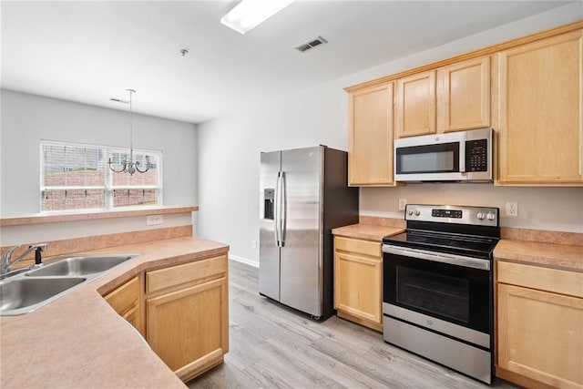 181 Ridgemont Rd, Canton, GA 30114 - kitchen featuring appliances with stainless steel finishes, light brown cabinets, a sink, light wood-style flooring, and light countertops