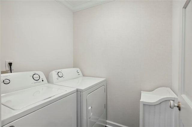 washroom with laundry area, baseboards, and washing machine and clothes dryer