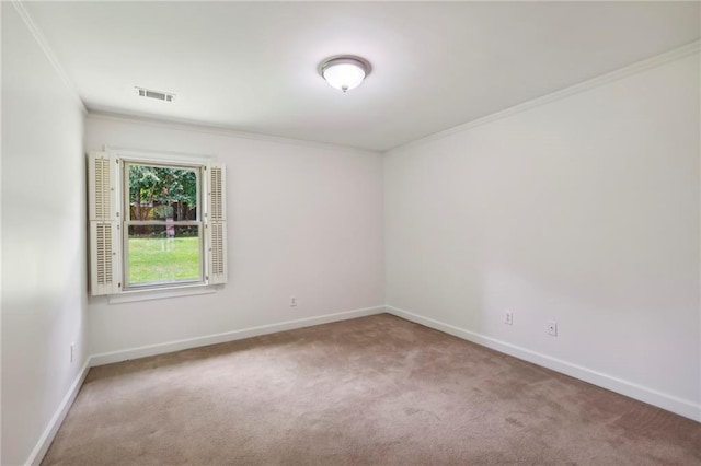 empty room featuring baseboards, crown molding, visible vents, and carpet flooring