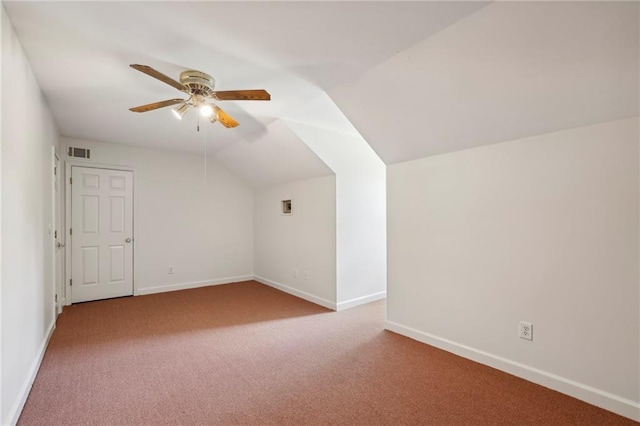 bonus room featuring baseboards, visible vents, a ceiling fan, vaulted ceiling, and carpet flooring