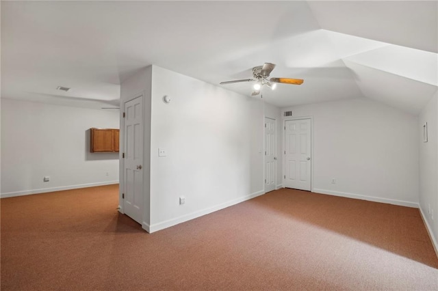 additional living space with carpet floors, baseboards, vaulted ceiling, and a ceiling fan