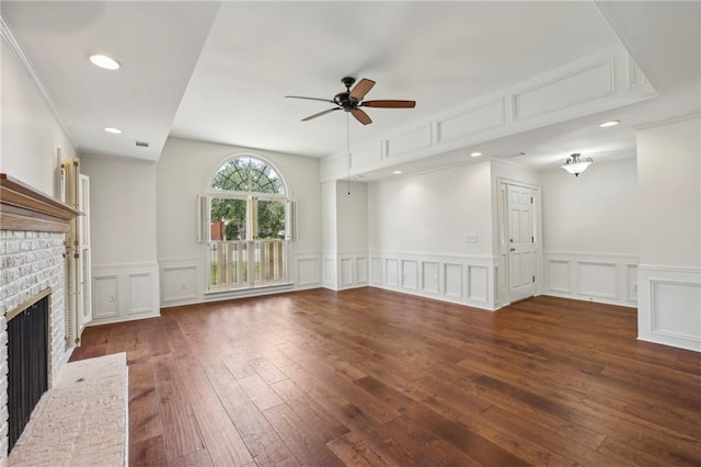 unfurnished living room with a ceiling fan, hardwood / wood-style floors, a fireplace, a decorative wall, and recessed lighting