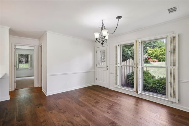 unfurnished dining area with a notable chandelier, visible vents, baseboards, ornamental molding, and dark wood finished floors