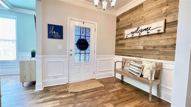 109 Red Fox Dr, Dallas, GA 30157 - foyer featuring ornamental molding, a chandelier, healthy amount of natural light, wood finished floors, and a wainscoted wall
