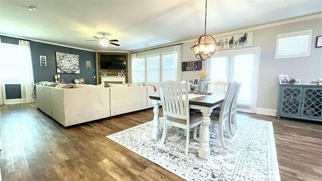 109 Red Fox Dr, Dallas, GA 30157 - dining space with crown molding, dark wood-type flooring, a ceiling fan, and a chandelier