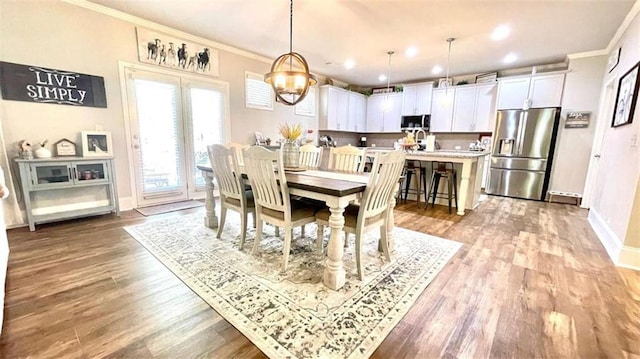 109 Red Fox Dr, Dallas, GA 30157 - dining area with crown molding, wood finished floors, a chandelier, and recessed lighting