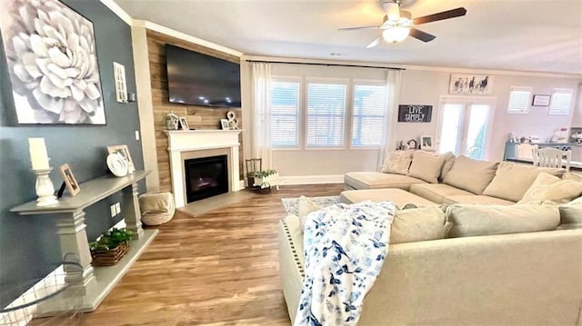 109 Red Fox Dr, Dallas, GA 30157 - living area featuring a fireplace, ceiling fan, crown molding, wood finished floors, and healthy amount of natural light