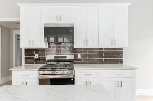 1232 Lucile Ave SW, Atlanta, GA 30310 - kitchen featuring stainless steel appliances, light stone counters, backsplash, and white cabinets