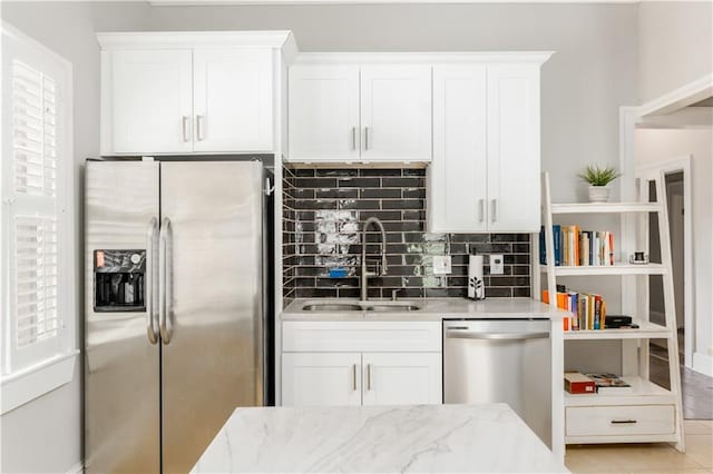 1232 Lucile Ave SW, Atlanta, GA 30310 - kitchen with appliances with stainless steel finishes, tasteful backsplash, white cabinetry, and light stone counters