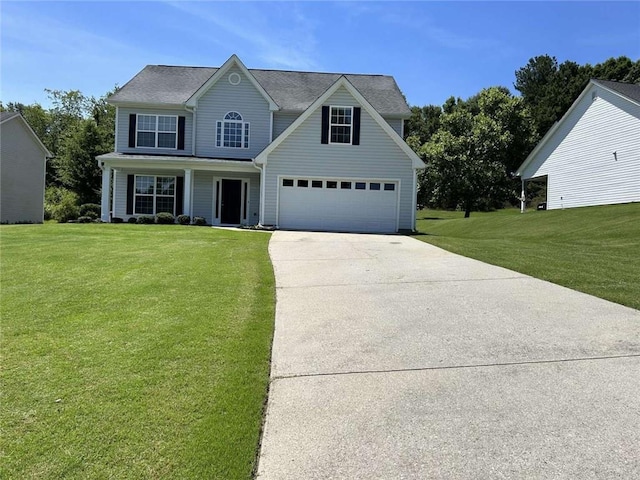 view of front of home with a front yard and a garage