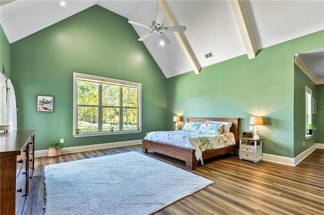 bedroom with ceiling fan, high vaulted ceiling, wood finished floors, visible vents, and baseboards