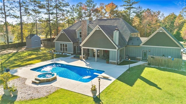 back of property featuring a fenced in pool, a patio, a shed, an in ground hot tub, and an outdoor structure