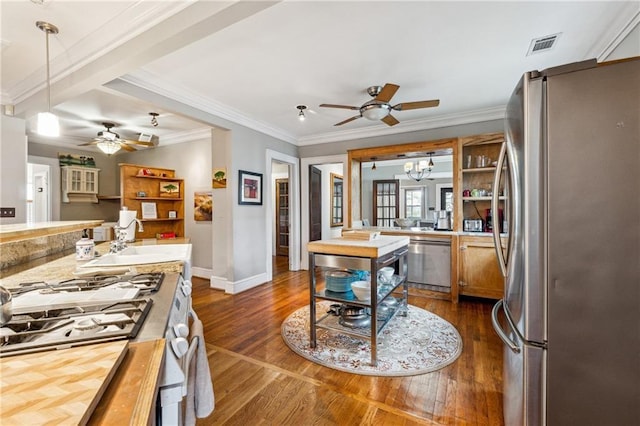 698 Bellemeade Ave NW, Atlanta, GA 30318 - kitchen featuring appliances with stainless steel finishes, a ceiling fan, a sink, dark wood-style floors, and ornamental molding