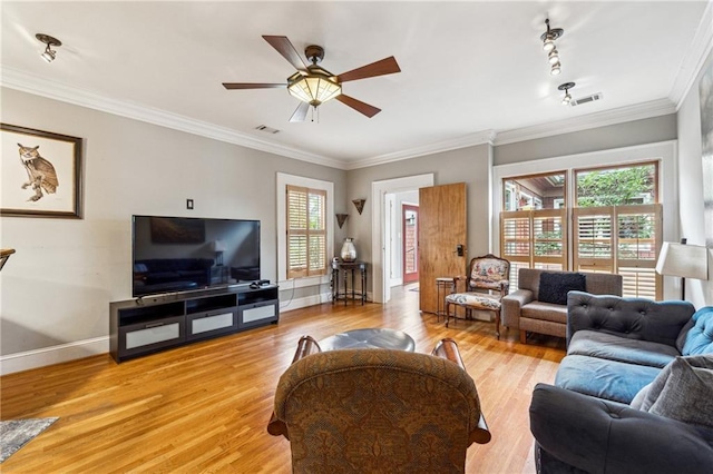 698 Bellemeade Ave NW, Atlanta, GA 30318 - living room with healthy amount of natural light, a ceiling fan, light wood-type flooring, baseboards, and ornamental molding